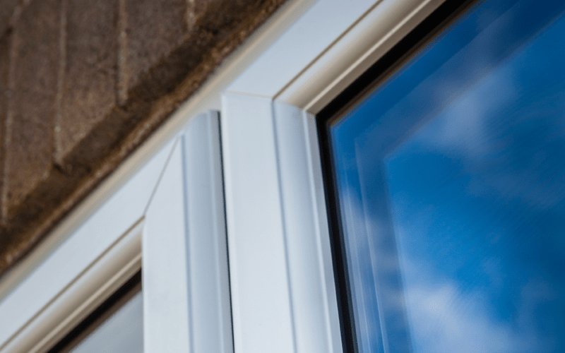 Closeup Of White UPVC On Brick Property