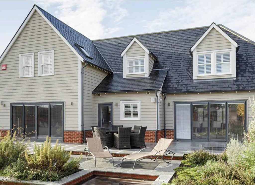 Two-tone house with a garden, sunloungers, and double-glazed windows
