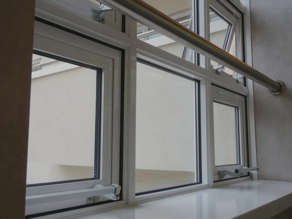 Set of double glazed windows with a pipe running in front of them